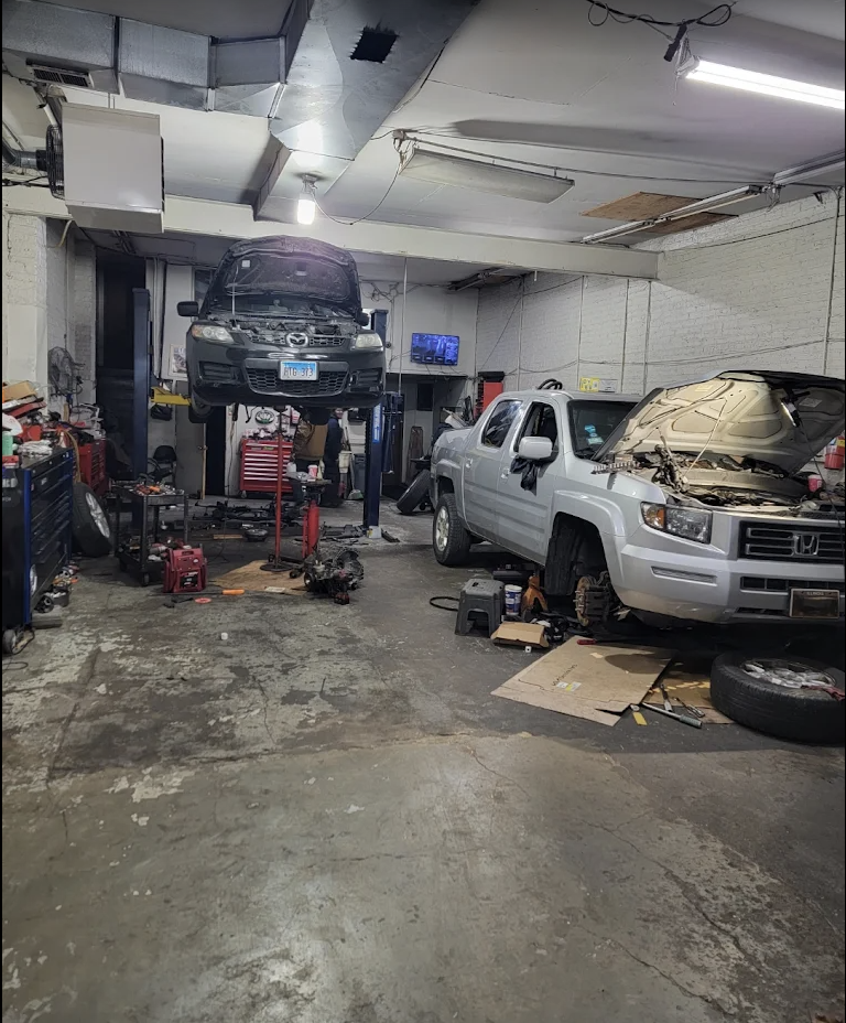 Full-service auto repair bays with multiple vehicles on lifts